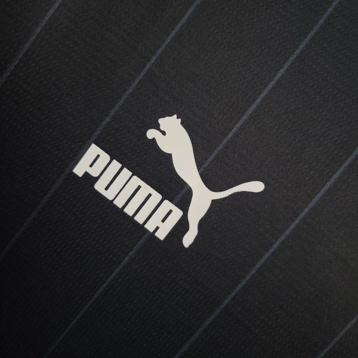 NEW ZEALAND 2026 HOME - Puma logo on black merchandise, perfect for fans gearing up for the upcoming season.